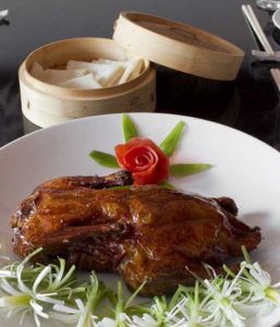 Authentic Peking Duck artfully presented on a plate at a renowned restaurant in the Greater Philadelphia area
