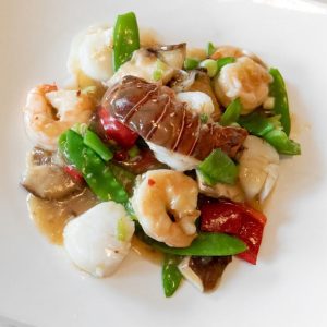A plate of elegantly prepared shrimp, lobster tail and scallops at an award winning authentic Chinese restaurant