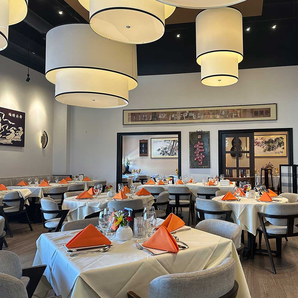 Modern restaurant dining room with set tables at Margaret Kuo's Kitchen, an Authentic Chinese and Gourmet Sushi restaurant